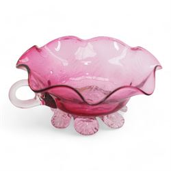 Early 20th century Bohemian cranberry glass flower form plate, overlaid with opaque and hand painted and gilded with a floral bouquet, D19.5cm, pair of cranberry glass pulpit vases, satin glass ewer and two further pieces of cranberry glass (6)