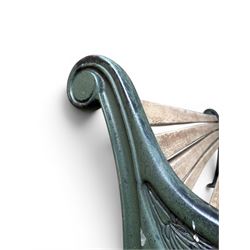 Neoclassical design cast iron and oak slatted garden bench, the twin end supports in the form of a Sphinx with acanthus carved knees and large paw feet, the pierced lattice bracket with Yorkshire rose motifs