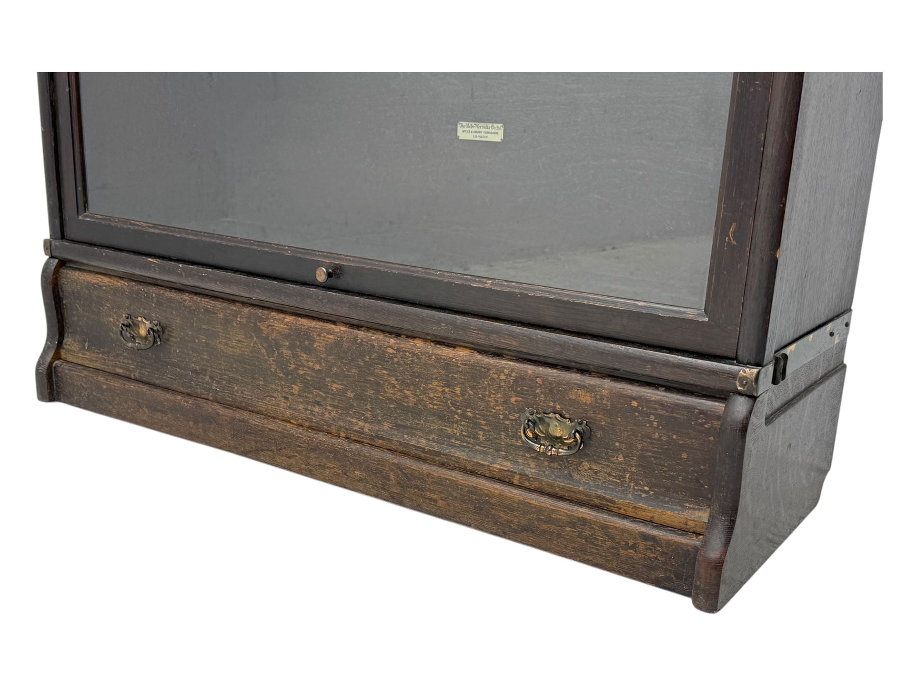 Globe Wernicke - early 20th century oak three-tier stacking library bookcase, three glazed sections enclosed by hinged and sliding doors, raised above a single lower drawer with metal drop handles