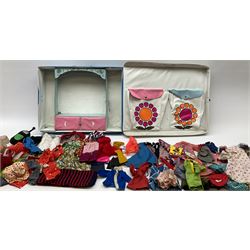 The World of Barbie Double Doll Case containing a quantity of assorted doll's clothing; together with two large and one small fashion dolls.