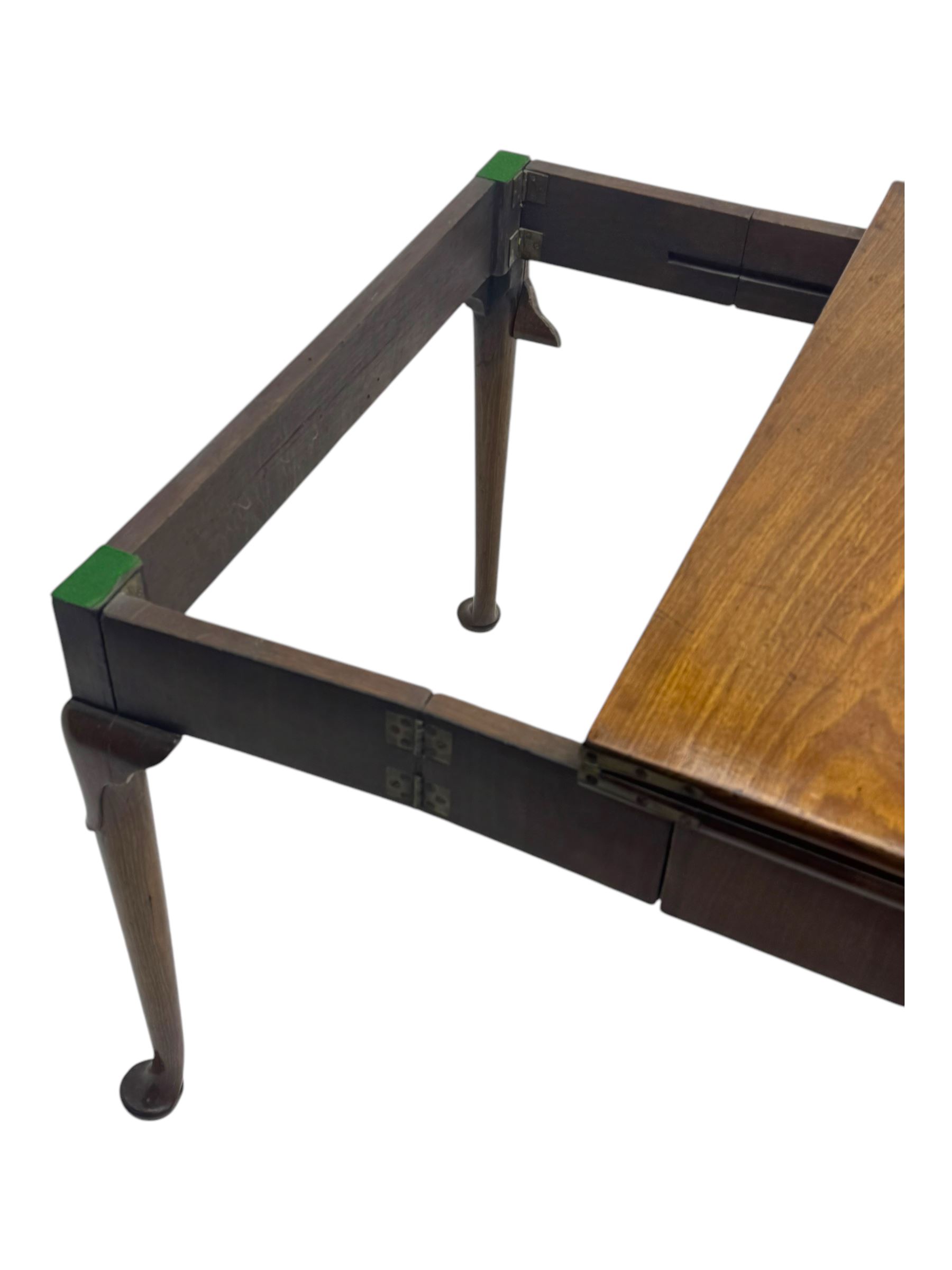 George III mahogany fold-top card table, shaped rectangular top opening to reveal a baize-lined surface, supported by a concertina pull-out concertina rear mechanism, raised on cabriole supports with foliate carvings terminating in pad feet