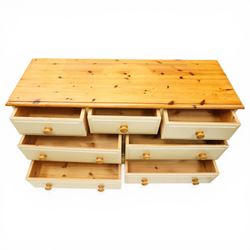 20th century painted pine chest, rectangular top over an assortment of seven drawers, on skirted base