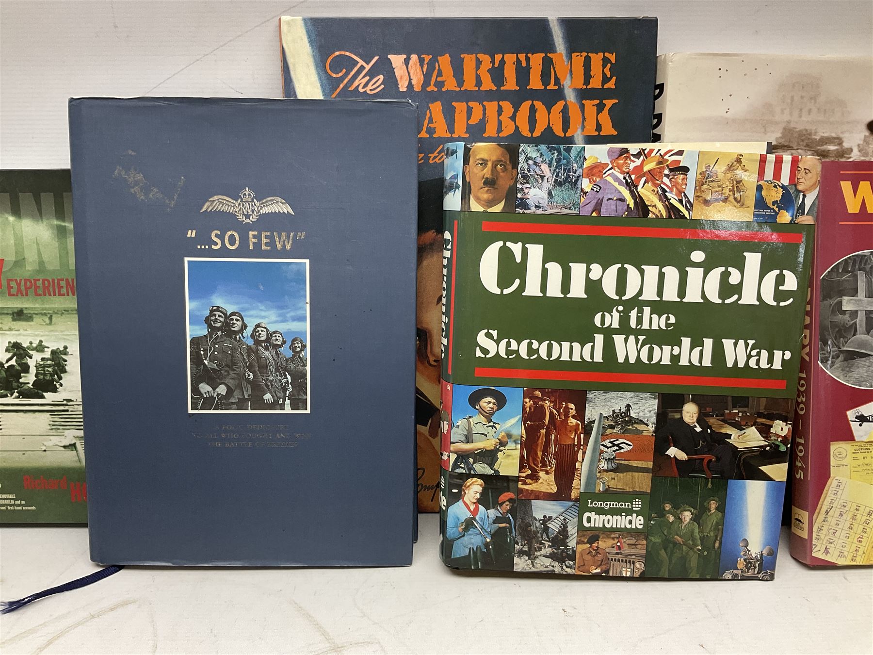 Thirty modern books of military interest including The Wartime Scrapbook 1939-1945; D-Day by Stephen Badsey; The D-Day Experience by Richard Holmes; Desert Rats by John Parker; A Most Secret Squadron by Des Curtis; Flying Colours - The Epic Story of Douglas Bader by Laddie Lucas etc; and quantity of DVDs of war and military interest