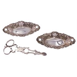 Small pair of Victorian silver trinket dishes, each of lozenge form with pierced sides and C scroll rim, hallmarked Walter & John Barnard, London 1895, L11.5cm, together with a pair of Georgian silver scissor action sugar nips with shell shaped bowls, possibly late George II or early George III, makers mark H.P, probably for Henry Plumpton, approximate total weight 2.49 ozt (77.7 grams)