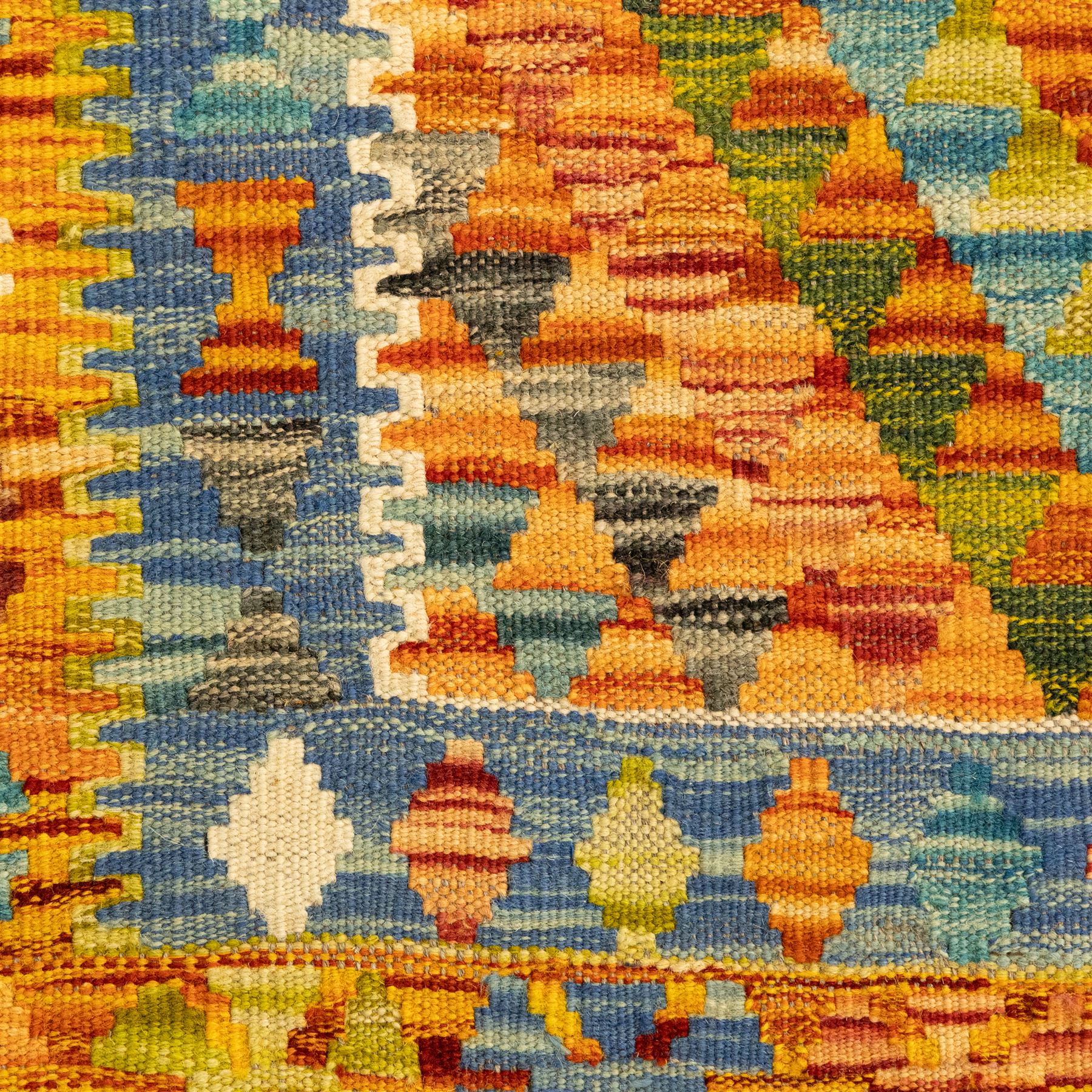 Two Chobi Kilim flatweave rugs, comprising the largest kilim on a cream ground with a grid of stepped diamond medallions in a palette of rust red, turquoise, green, ochre, and lilac,, filled lozenge motifs, framed by a cream ground border, 148x101cm, Chobi Kilim with multi-stepped diamond medallion with serrated bands, in terracotta, turquoise, green, saffron and blue, framed by a broad polychromed border of stylized guls and narrow guard stripes, 114x87cm 