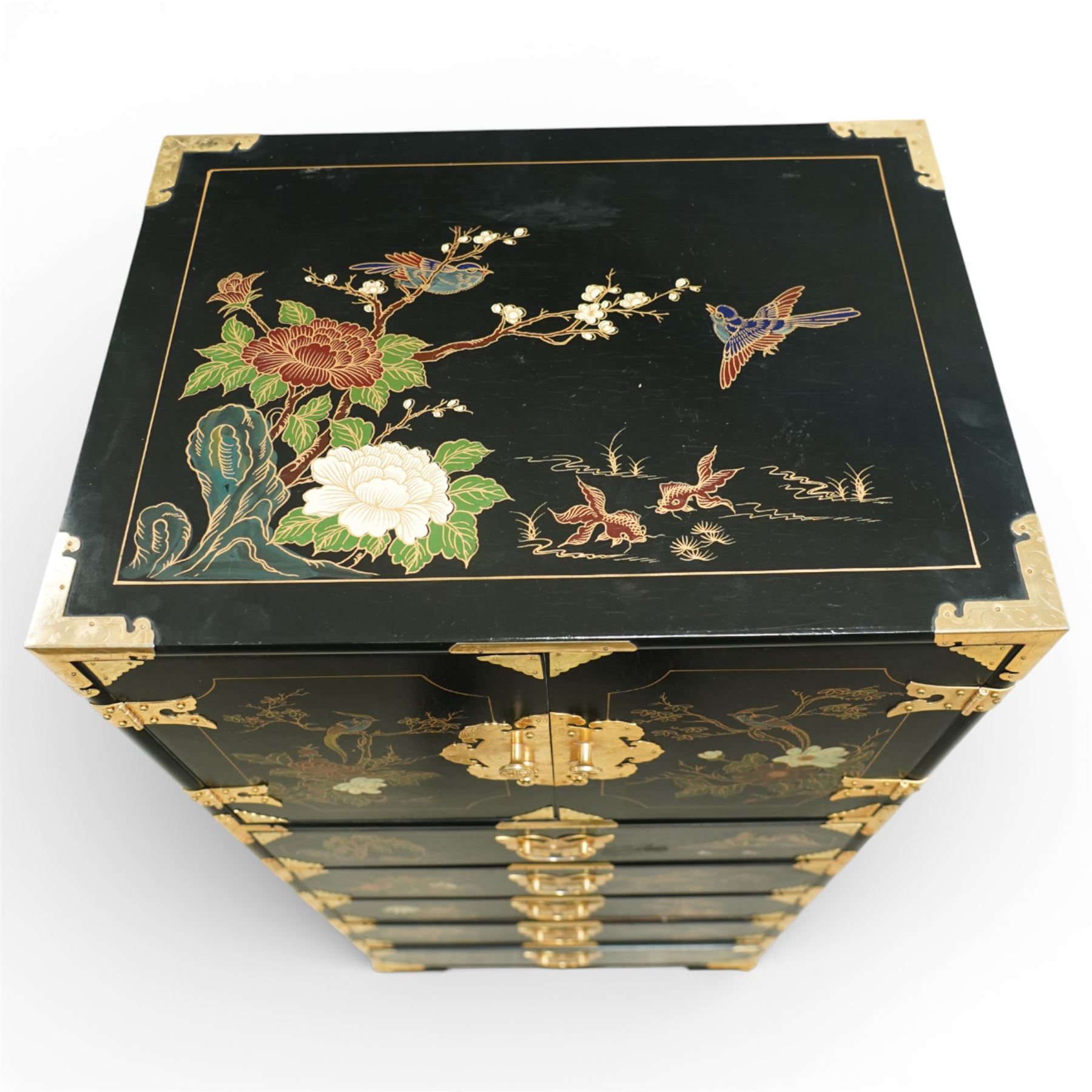 Japanese Shibayama style black lacquered curio chest, cupboard doors enclosing four short over two long fitted drawers, decorated in gilt with birds, flowers and landscape scenes, raised on gilt mounted bracket feet