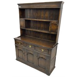 Georgian design oak dresser, the two-tier plate rack with two flanking spice cupboards, the base fitted with three drawers over three arched fielded panelled cupboards, lower moulded edge on block feet