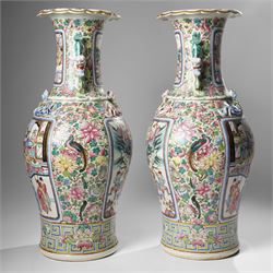 Large pair of 19th century Cantonese famille rose vases, each painted with various courtly scenes, including a display of warriors fighting on horseback before an official and his attendants, double Buddhist lion handles and applied at the shoulders with chilong, the lower band painted with Greek key motif, H58cm (2)