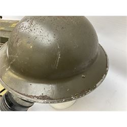 WW2 British steel combat helmet with original green combat paint finish to the exterior and interior of the shell; dated 1939 with liner and webbing chinstrap; WW2 pair of British army webbing leg gaiters and belt; respirator and green painted cartridge tin