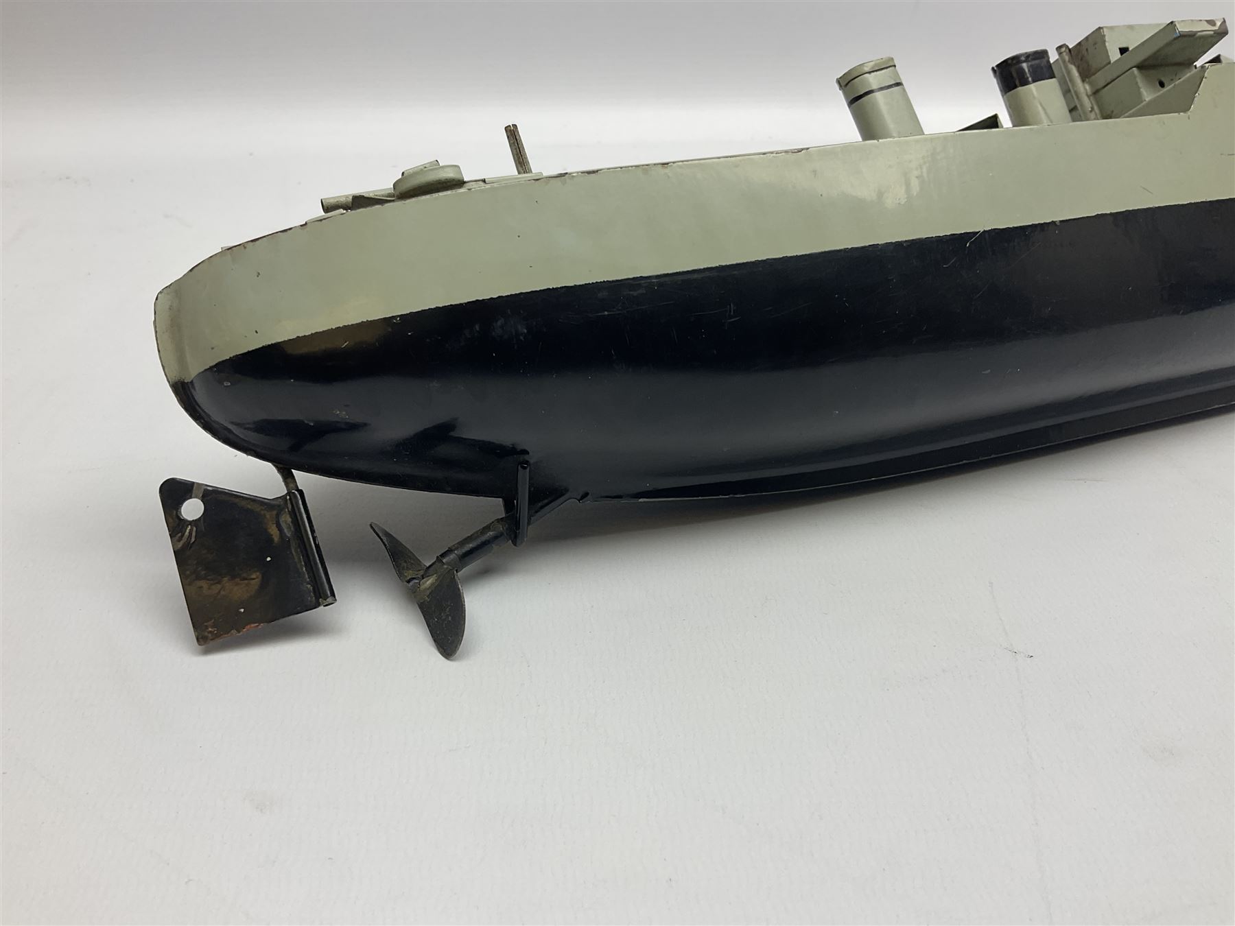 Pre-war Sutcliffe Grenville tinplate clockwork Battleship, with black and grey hull, grey deck and upper decks, propeller and rudder, length 32cm; with manuscript biographical details and two keys, unboxed