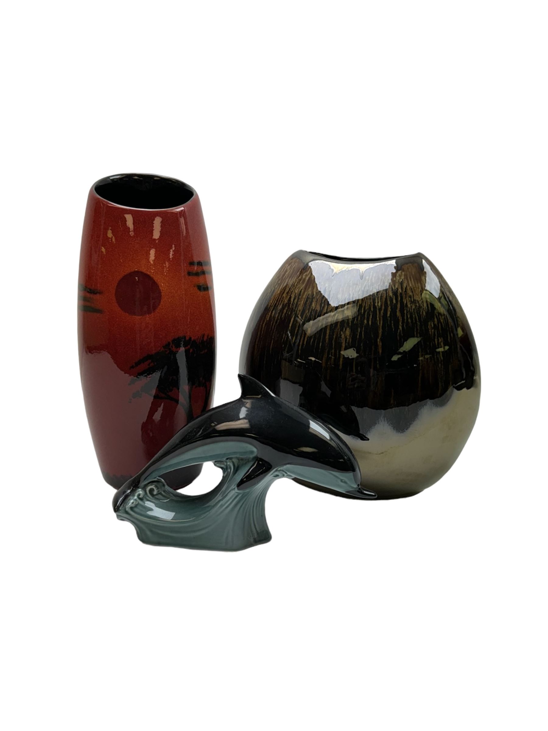 Poole pottery Form vase by Andrew Tanner, decorated with a silhouette of a tree beneath a red sun, together another with Poole pottery vase and dolphin, largest H24cm 