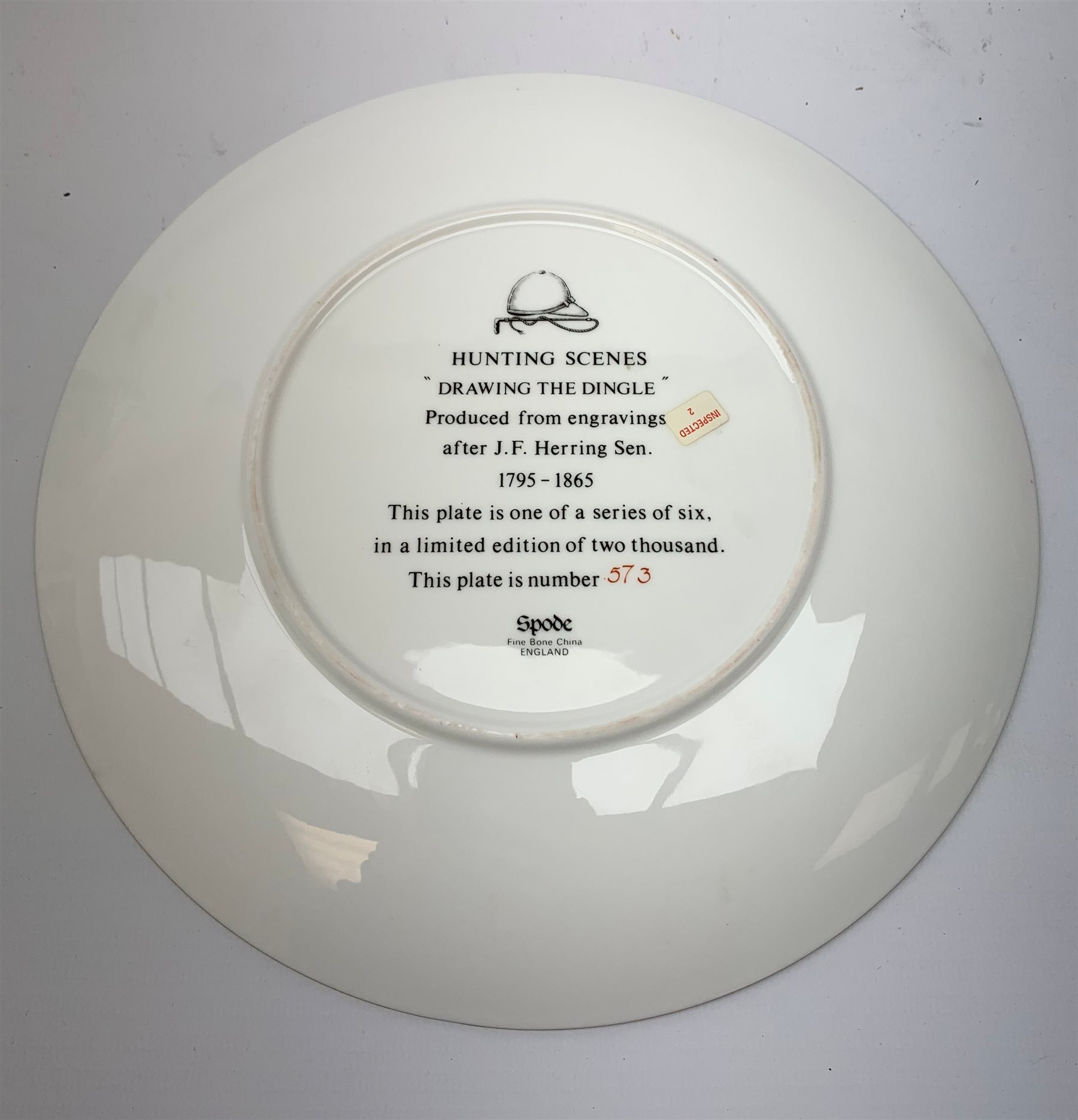  A collection of hunting related items, comprising a pair of Caverswall beakers, each with twin gilt fox head handles, H11.5cm, a limited edition Spode cabinet place depicting 'Drawing the Dingle' after J F Herring Sen, D24cm, and a set of six French shot glasses, decorated with huntsmen on horseback and hounds, H5.5cm.  