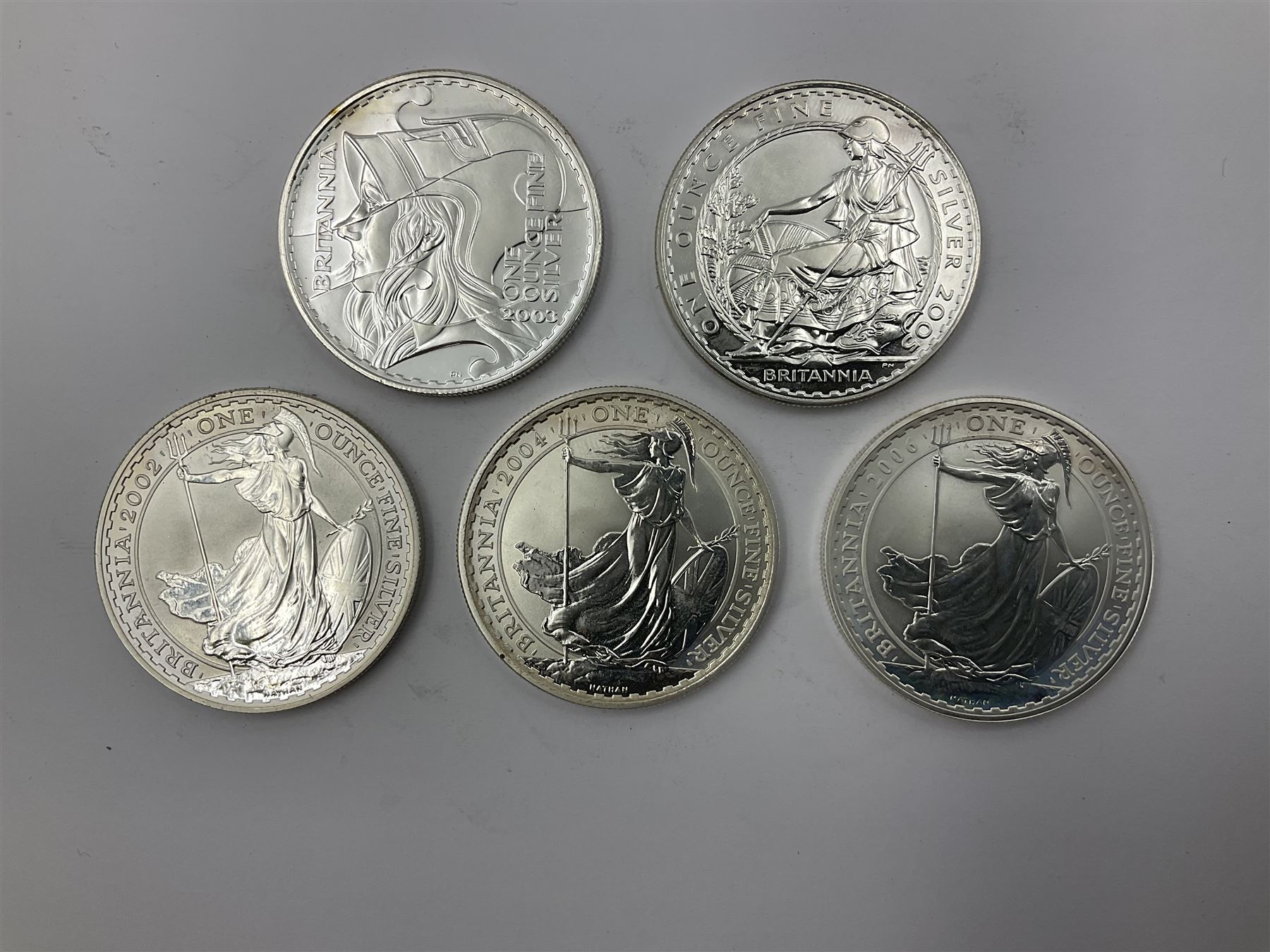 Five Queen Elizabeth II United Kingdom one ounce fine silver Britannia two pound coins dated 2002, 2003, 2004, 2005 and 2006