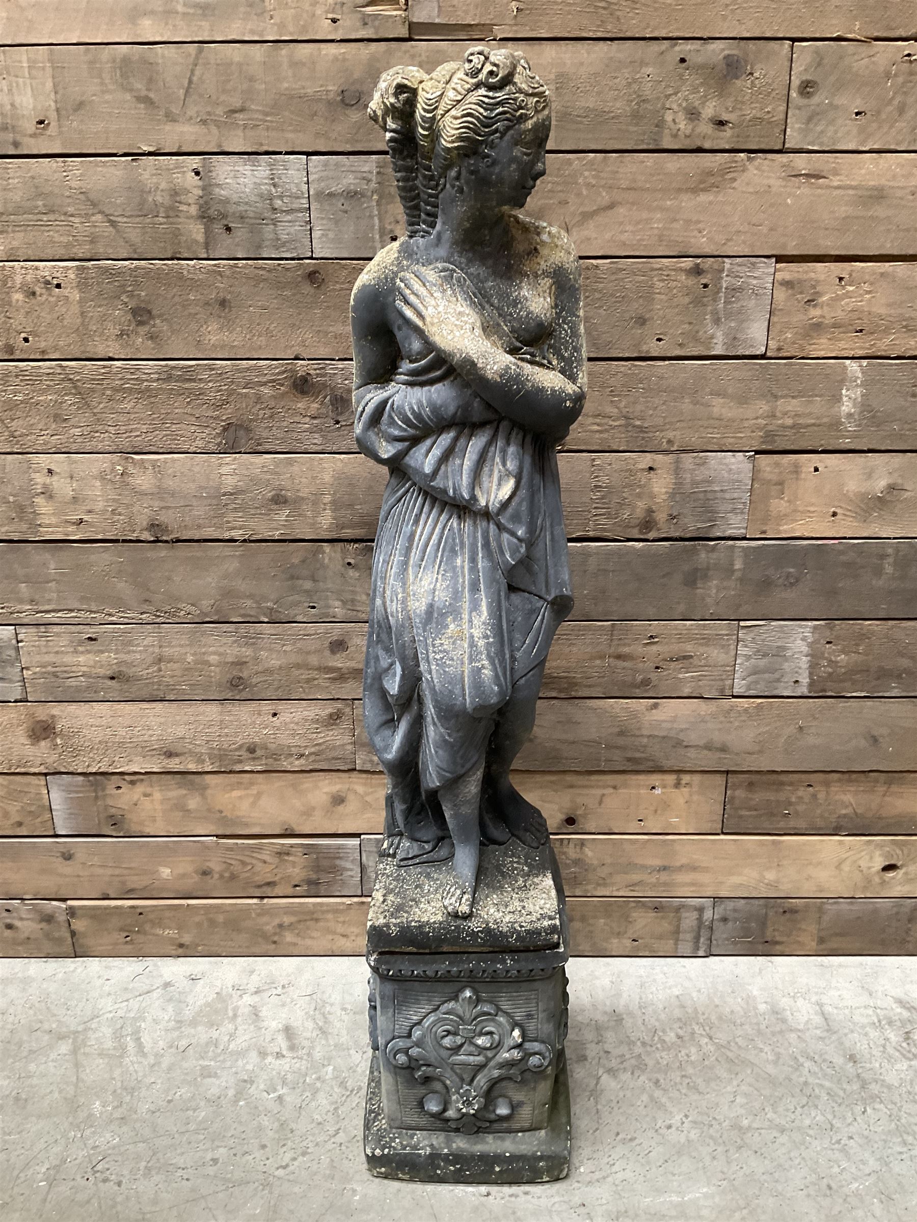 Cast stone weathered garden statue of Venus on pedestal