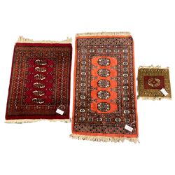 Two small Persian Bokhara rugs (largest - 106cm x 64cm), and a small mat decorated with Gul motif