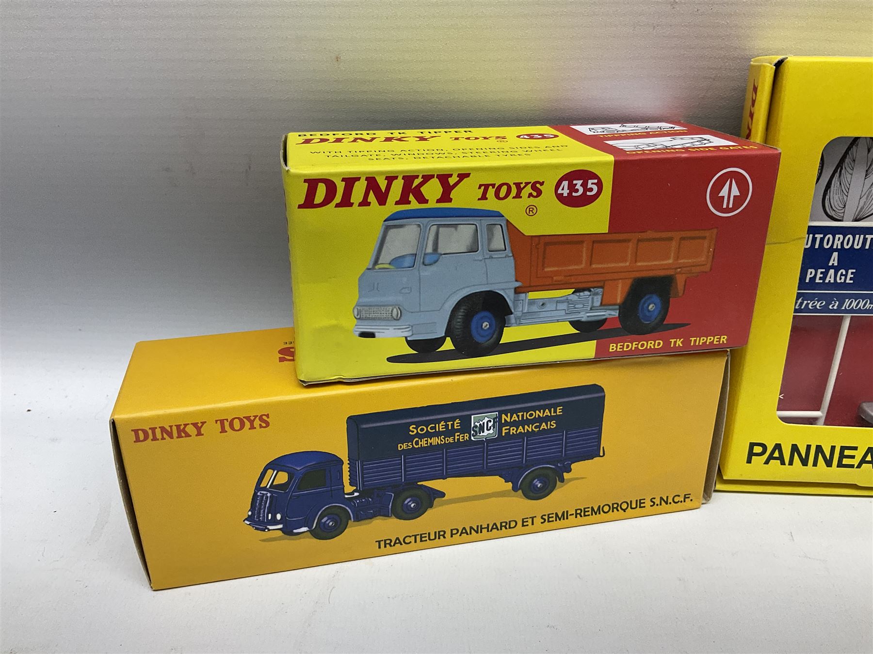 Ten Atlas Dinky die-cast models and accessories including, Bedford TK Tipper no. 435, Austin Wagon no. 412, two Miniatures, 25 O Camion Laiter, 'Panneaux De Signalisation Routiere' and others (10)