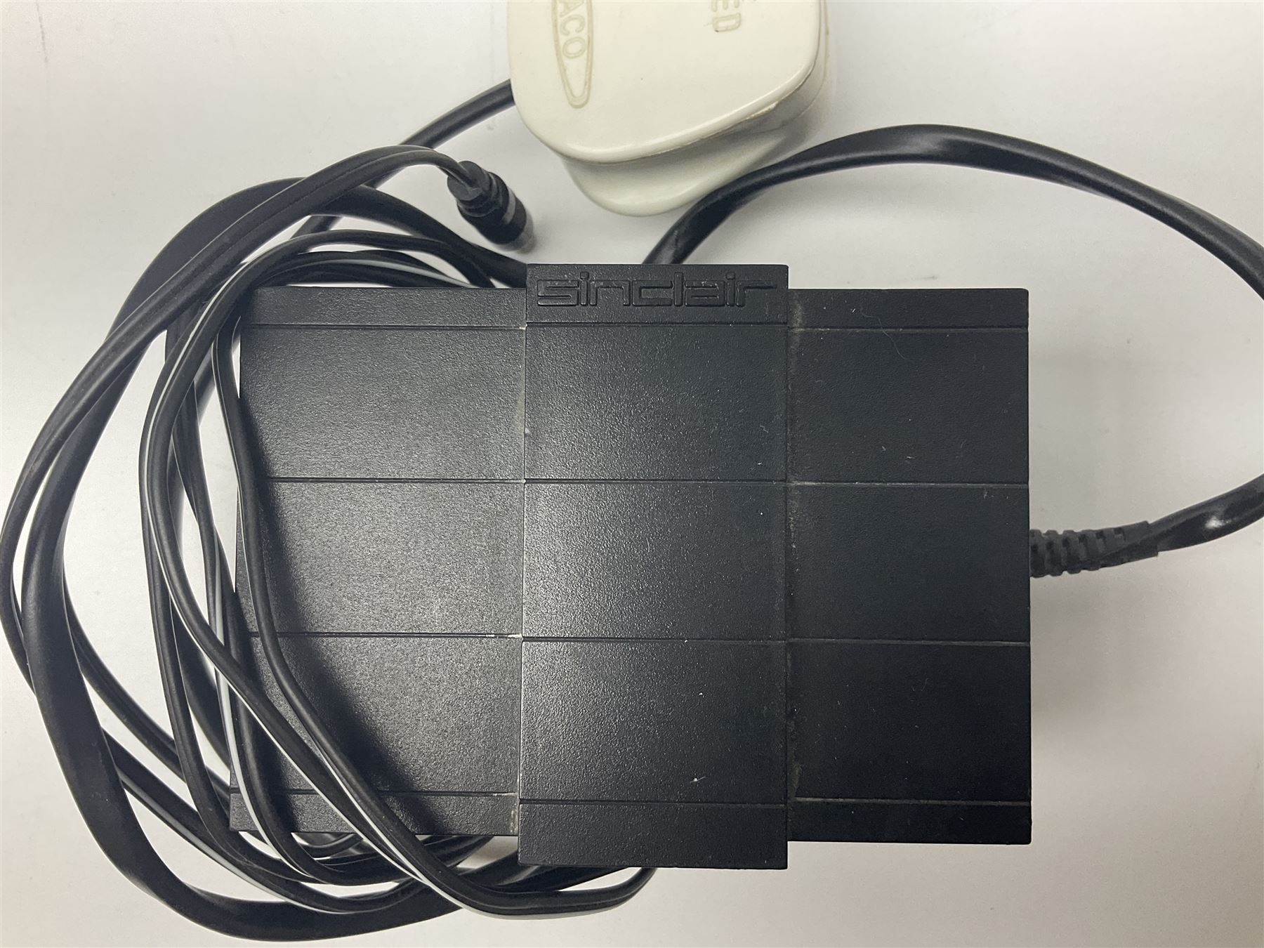 Sinclair ZX Spectrum (1984) with accessories and games; ten games for Sinclair Spectrum and 48K Spectrum to include ‘Knight Lore’, ‘The Way of the Exploding Fist’, and ‘Green Beret’ all in original boxes, ‘Rambo First Blood Part II’ without original box; Sinclair UK1400 Power Supply Unit, Hales Universal Mains Adapter, RAM Turbo Spectrum Joystick Interface, Starlite Cassette Player, all without boxes