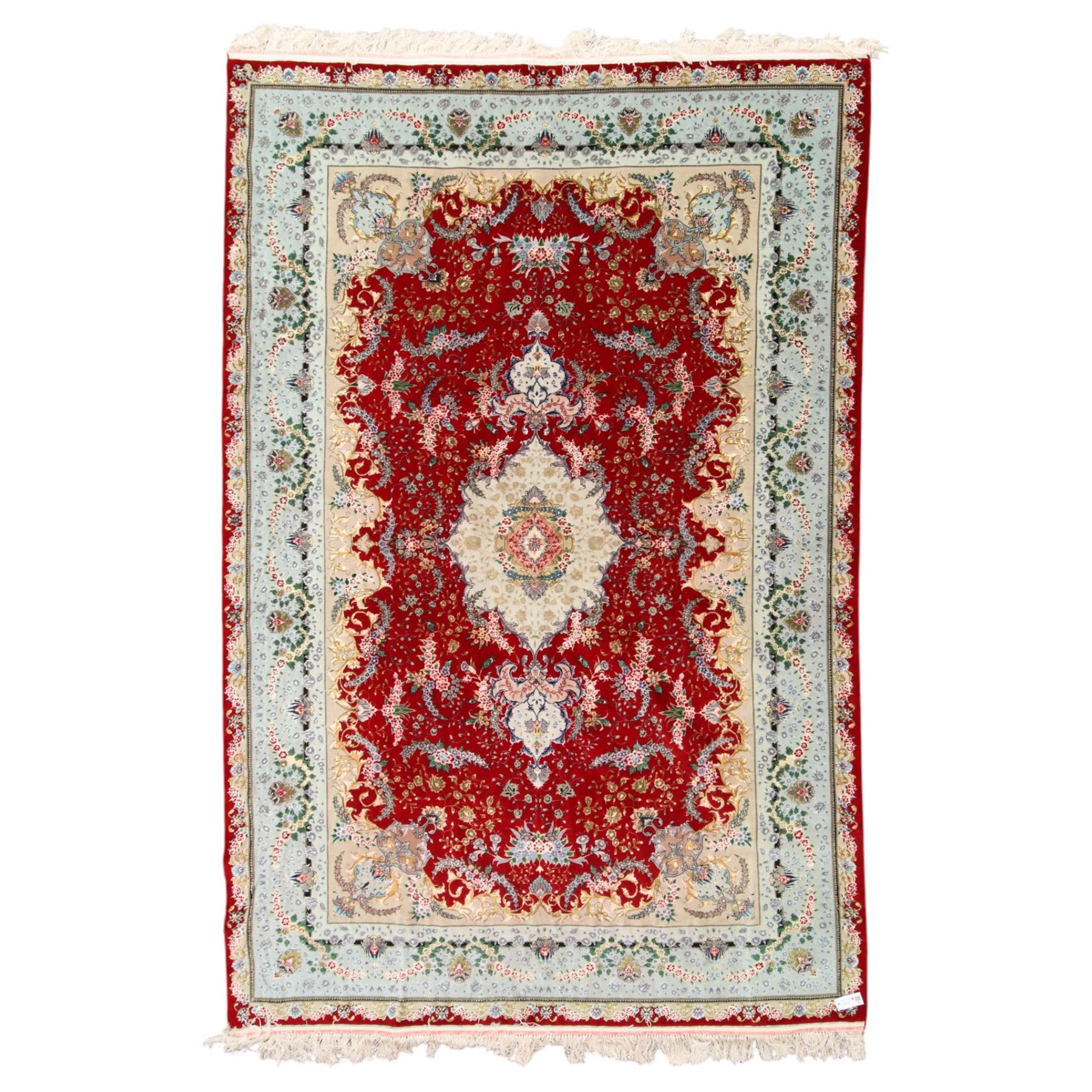 Fine Persian silk inlaid crimson ground Tabriz rug, the shaped field decorated with a central foliate pole medallion filled and surrounded by finely knotted floral motifs and trailing foliage, the cyan guard stripe with bold festoons and palmette motifs