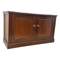 Victorian mahogany cupboard, plain rectangular top above two fielded panel doors opening to shelved interior, raised on a moulded plinth base, with later replacement knob handles
