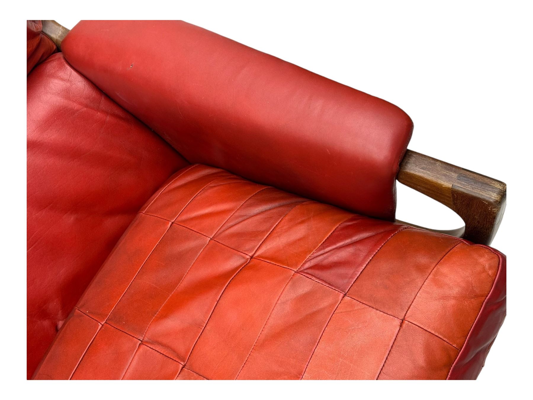 Folke Ohlsson for Gimson & Slater - mid-20th century Danish teak-framed sofa, red leather upholstery with patchwork design, raised on shaped teak side supports