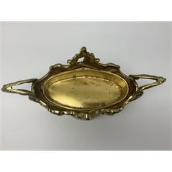 Ornate brass centrepiece, with twin handled vase upon a mirrored base, with floral and scrolling decoration, H23cm 