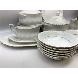 Chodziez Polish dinner wares decorated in white and gilt to include lidded twin handled tureens, bowls, plates etc