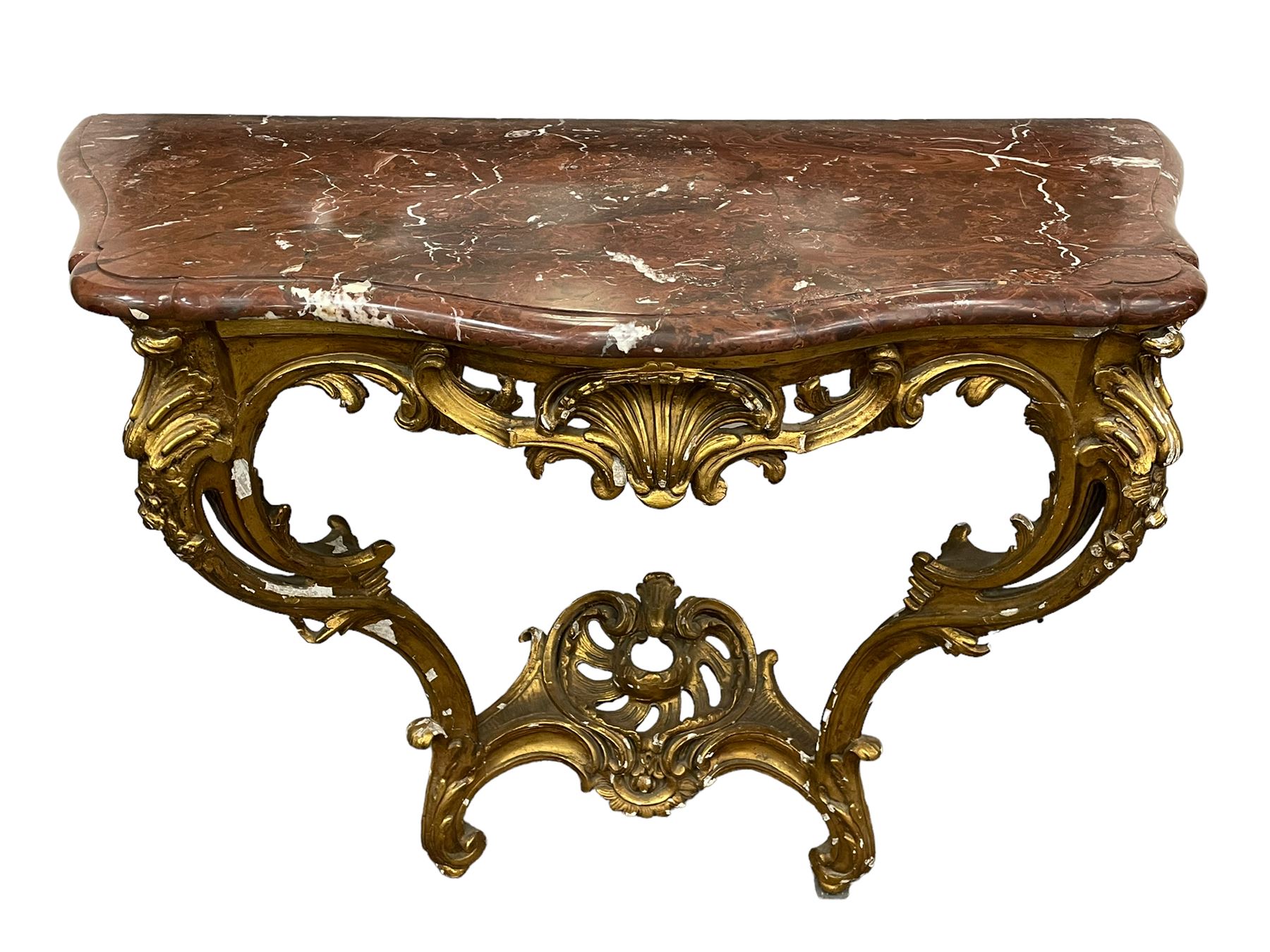 19th century giltwood and gesso console table, shaped variegated rouge marble top with moulded edge, central shell motif with extending scrolled foliage, on foliate and flower head moulded cabriole supports united by pierced shell middle rail, scrolled acanthus leaf terminals 