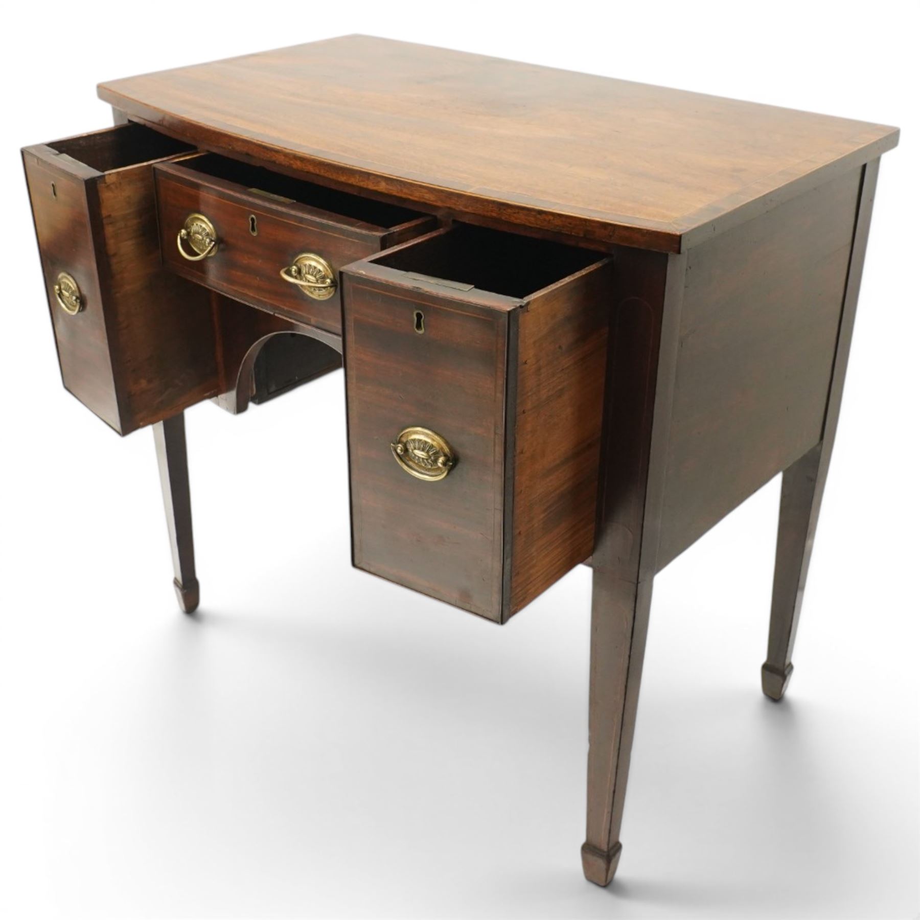 Small late 18th century inlaid mahogany sideboard, with bow fronted top with crossbanded edge, central drawer flanked by a drawer each side, kneehole cut out, raised on square tapering supports terminating in spade feet