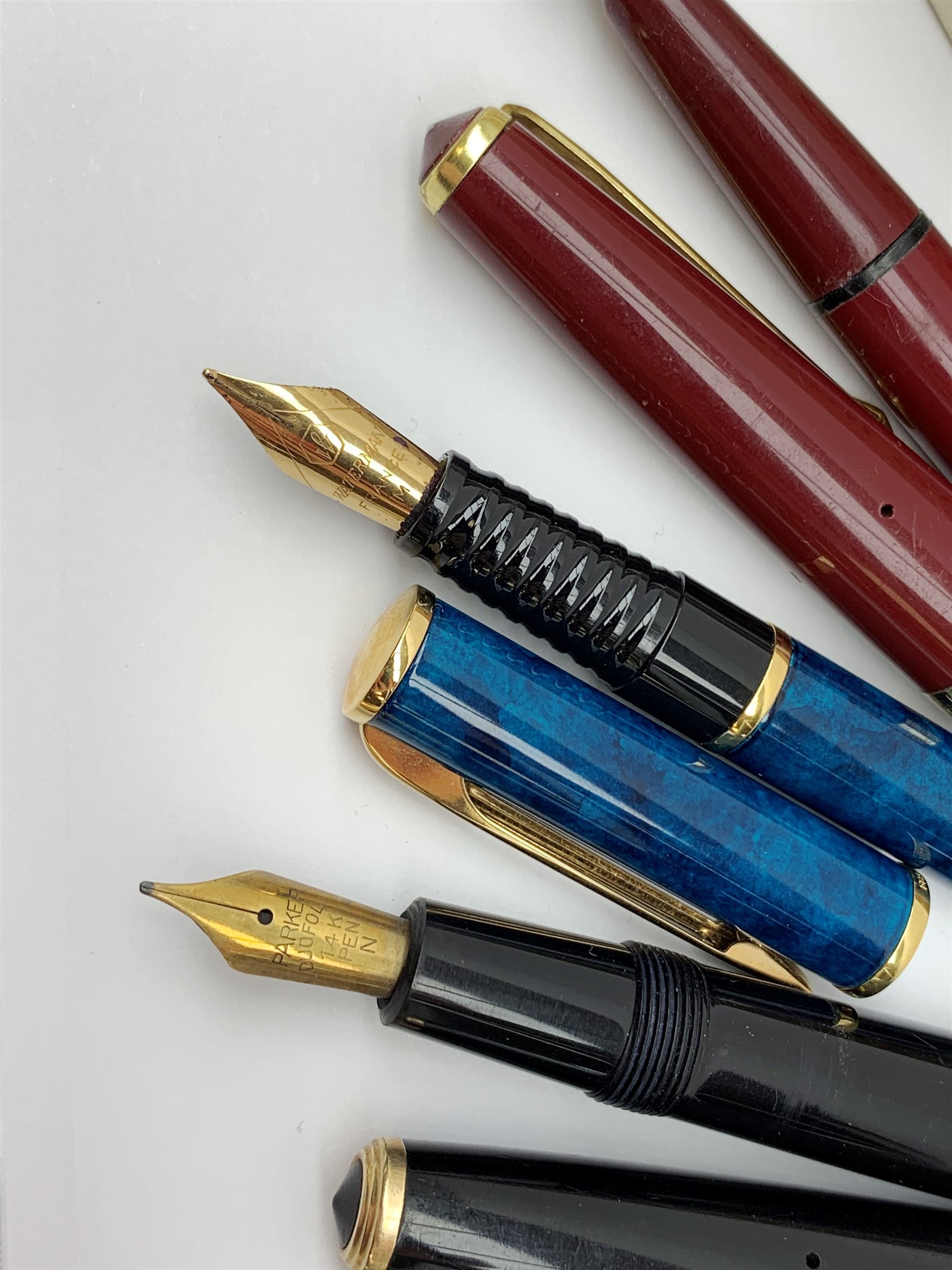 A group of four fountain pens, comprising Parker Duofold, nib marked 14K, Swan Mabbie Todd & Co Ltd Self Filler, nib marked 14C 585, Conway 57, nib marked 14ct, and Waterman Laureat. 