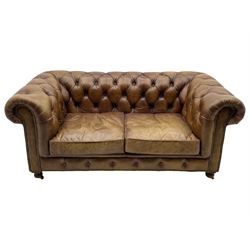 HALO - Chesterfield style two seat sofa upholstered in buttoned brown leather with stud work, on turned feet with castors