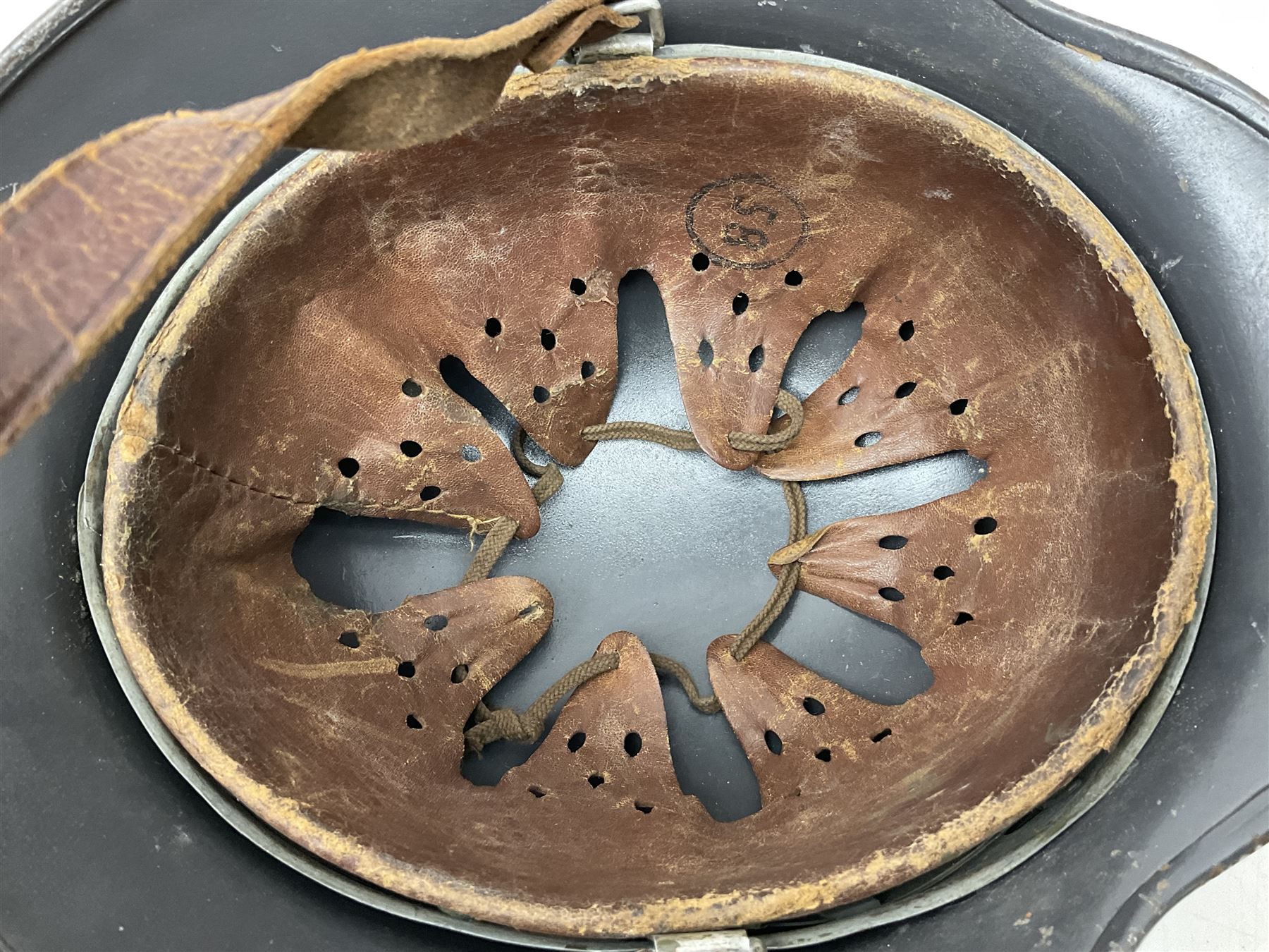 WW2 German steel helmet painted in undecaled Luftwaffe bluey grey with leather liner and chin strap stamped '58', the skirt impressed '1250'