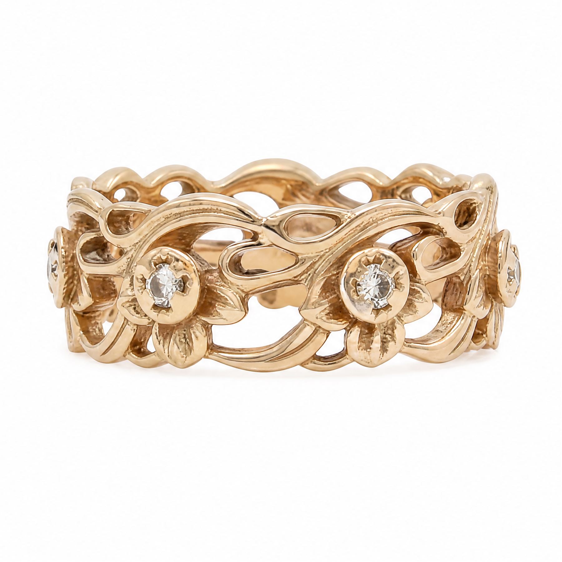 14ct rose gold diamond set band, pierced floral band set with seven round brilliant cut diamonds, stamped 14k