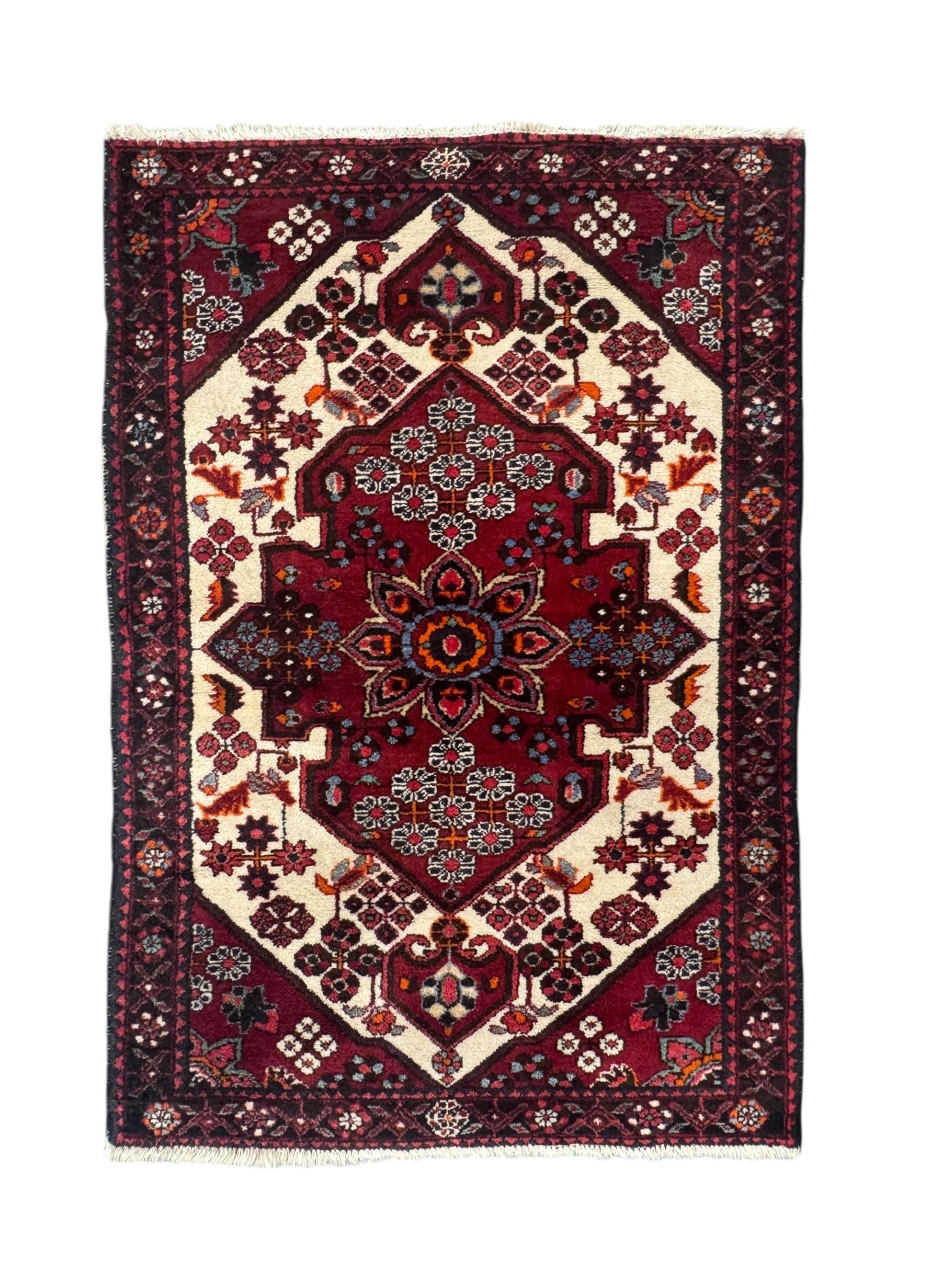 Persian Heriz wool rug, red and ivory field with floral medallion, geometric spandrels, and floral border (157cm x 107cm); Kurdish Shairwan wool rug, red and navy field with three medallions, geometric crosses and serrated border (200cm x 155cm); Persian Qashqai wool rug, golden-yellow field with boteh motifs and wide floral border (127cm x 82cm)