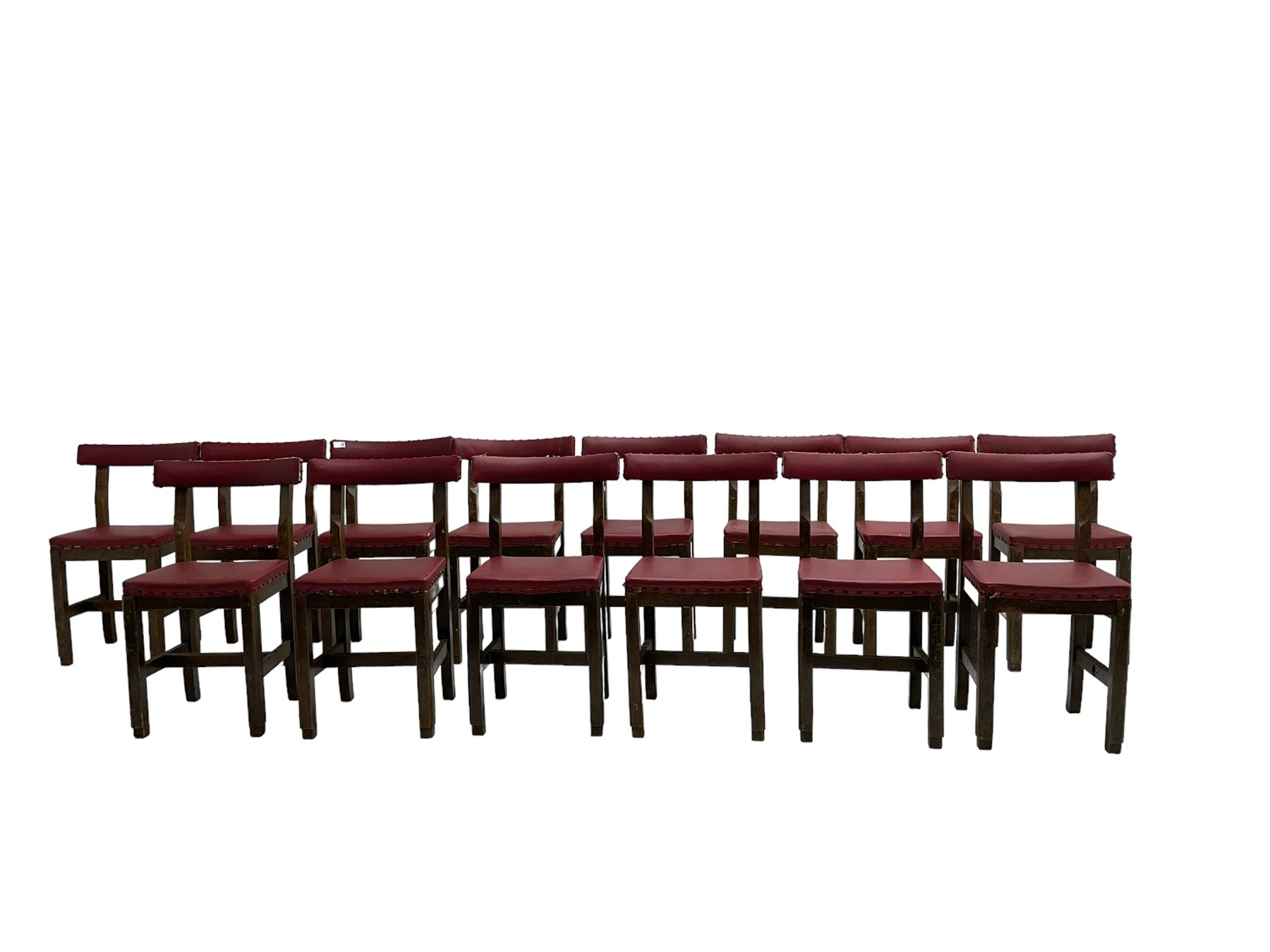Set fifteen early 20th century oak school chairs, back rail and seat upholstered in claret red faux leather with studwork, raised on square supports united by H-stretcher (15)
