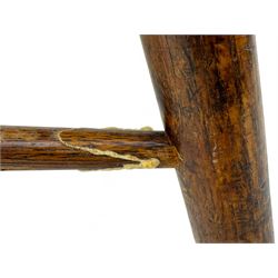 Early-to-mid 19th century elm and ash high-back Windsor armchair, central vase-shaped splat flanked by slender vertical spindles, outward-curving arms, shaped and dished saddle seat, raised on turned and splayed supports united by H-stretcher