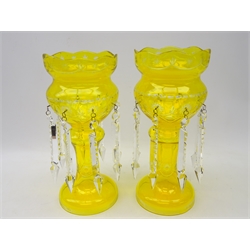 Pair 20th century Bohemian yellow tinted glass lustres, with star cut decoration, shaped top & hung with prism drops, H37cm   