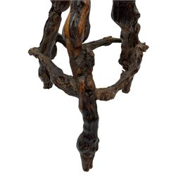 Mid-20th century French grapevine and walnut bow-front wine tasting bar, the curved counter top supported by sculptural grapevine roots, fitted with single shelf and raised on rustic vine feet (W100cm H101cm); with a pair of matching bar stools, the circular top raised on three gnarled root supports united by stretchers (W50cm H70cm)