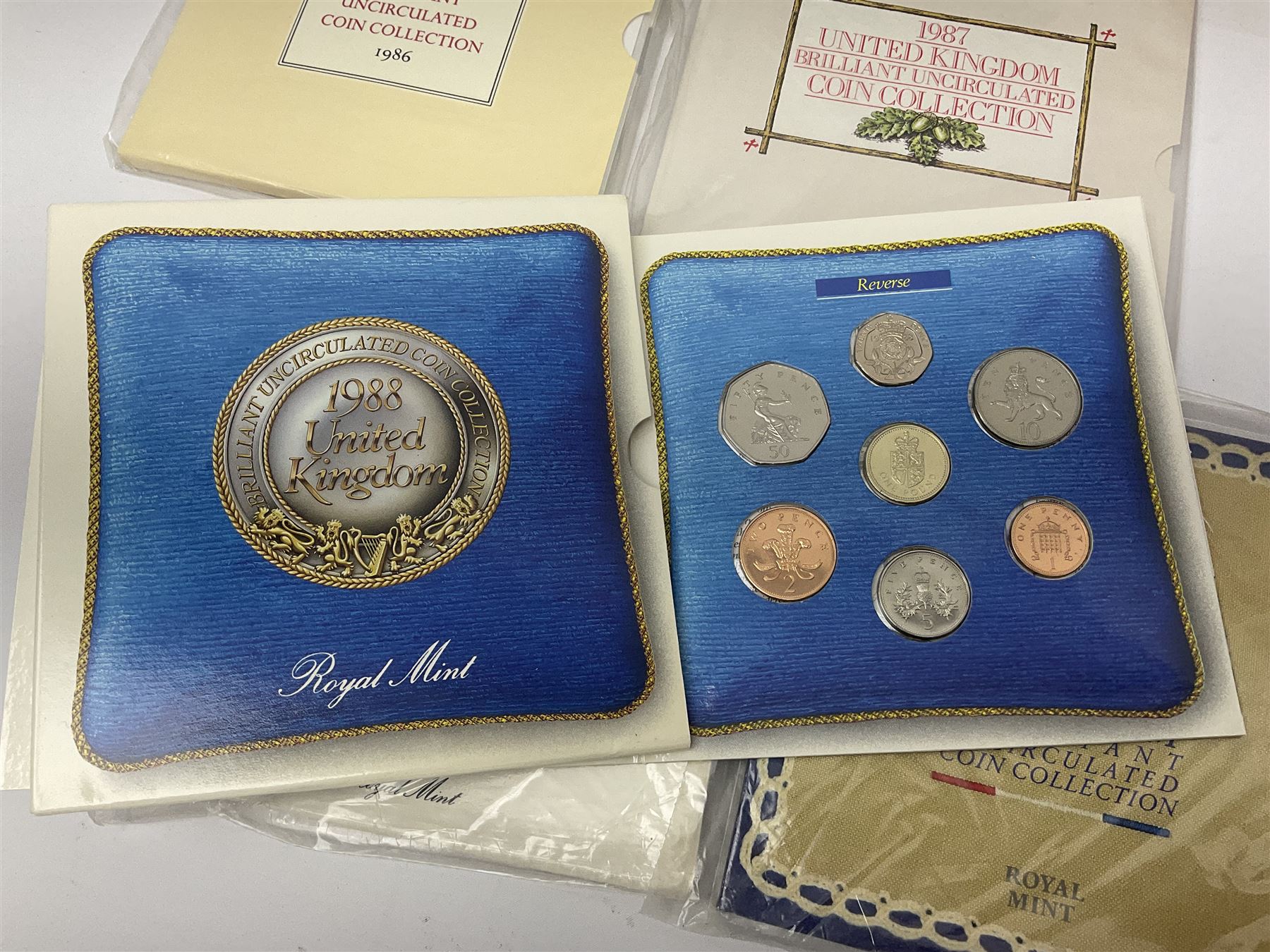 Fourteen Queen Elizabeth II United Kingdom uncirculated coin collections, dated 1983, 1984, two 1985, 1986, 1987, 1988, 1989, 1990, 1991, 1992 including dual dated 1992/1993 EEC fifty pence, 1994 and two 1995, all in card folders
