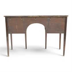Regency period inlaid mahogany bow-breakfront sideboard, shaped rectangular top with crossbanding and ebony stringing, central convex frieze drawer flanked by cupboard and cellarette drawer, over fan-inlaid spandrels, raised on square tapering supports