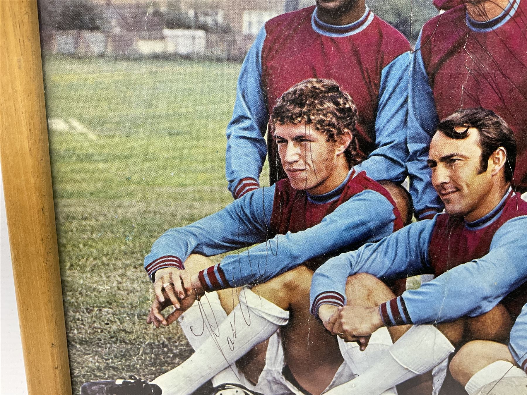 1970-1 photograph of West Ham United FC squad members, including Bobby Moore, Geoff Hurst, Harry Redknapp, Trevor Brooking, Jimmy Greaves, Billy Bonds etc, most players with signatures, 30 x 45cm, framed and glazed