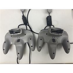 Nintendo 64 console, two controllers, games and accessories. Accessories to include the ‘Tremorpak’ and ‘Spook’ 2 Phono plugs and a S-VHS plug with adapter, both in original boxes. Games to include ‘Golden Eye 007’, ‘Doom 64’, ‘Killer Instinct Gold’, ‘Tetrisphere’, ‘F-1 World Grand Prix’, ‘Pilotwings 64’ and ‘Lylatwars’ with ‘Rumble Pak’, all with original boxes and instruction manuals. ‘Star Wars Episode I Racer’ game cartridge in Shadows of the Empire box. 