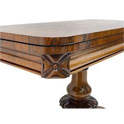 Victorian figured rosewood card table, fold-over swivel top with circular baize lining, moulded frieze with stylised flower head carving to corners, turned column with egg and dart decoration, on quadruple splayed c-scroll carved supports, with brass castors