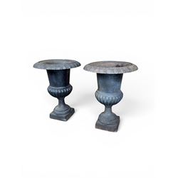 Pair of Victorian design heavy cast iron garden urns, black painted, egg and dart rim on waisted column