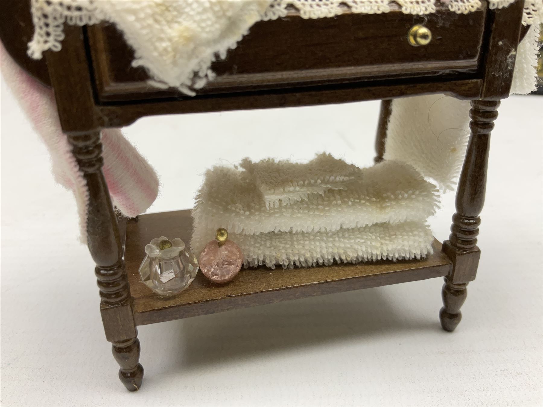 Collection of miniature dolls house furniture, to include five drawer chest painted with blossom, cream and gilt double door mirrored wardrobe, four piece lacquered style desk set, three piece suite, writing desk, wash stand, Knoll style sofa etc (14)