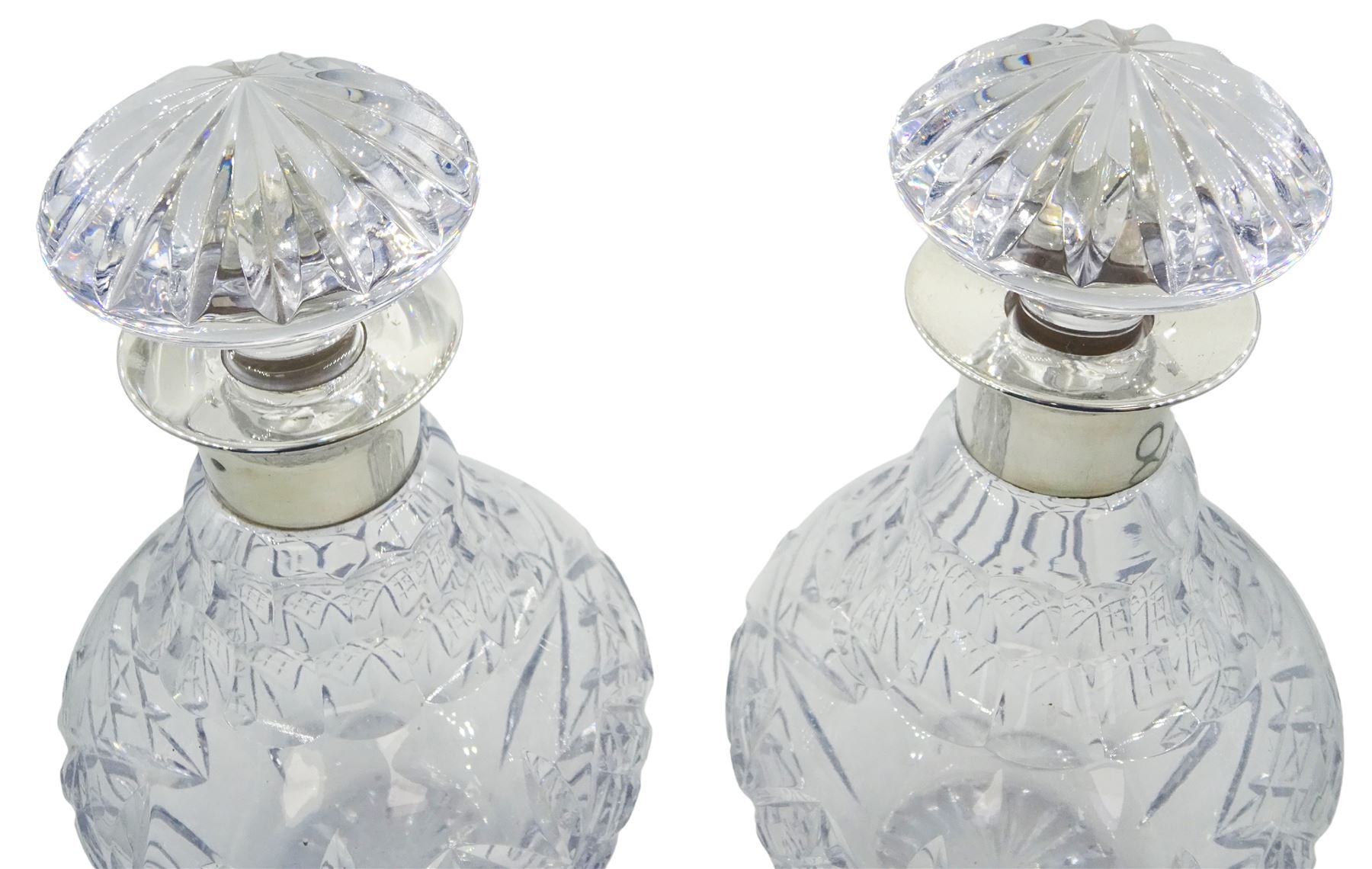Pair of modern silver mounted Royal Doulton cut glass decanters, of