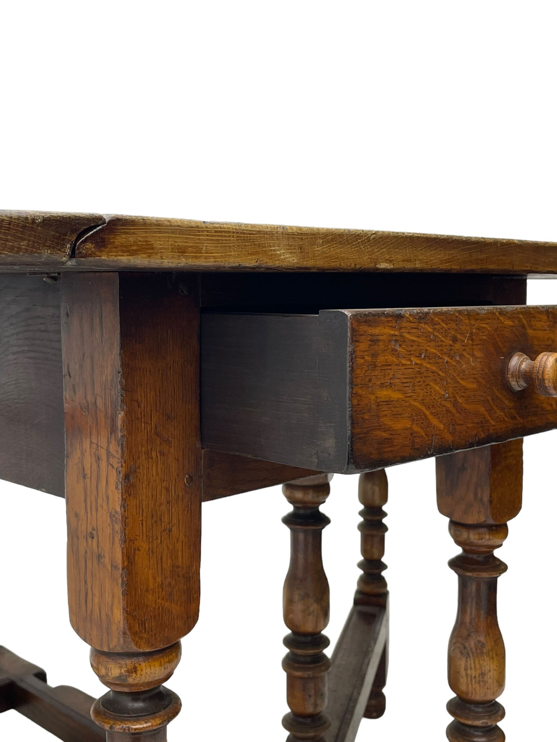 19th century oak dining table, oval drop-leaf top on gate-leg action base, turned supports united by turned stretchers, fitted with single end drawer