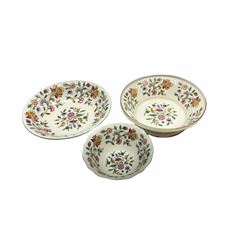 Minton Haddon Hall pattern tea and dinner wares, including basket dish, two covered tureens, six dinner plates, eight dessert plates, twelve tea plates, six soup bowls, six cereal bowls, teapot, coffee pot, milk jug, covered sucrier twelve tea cups and saucers, six mugs, footed bon bon dish, pair of candlestick holders, cake knife and slice etc (81)