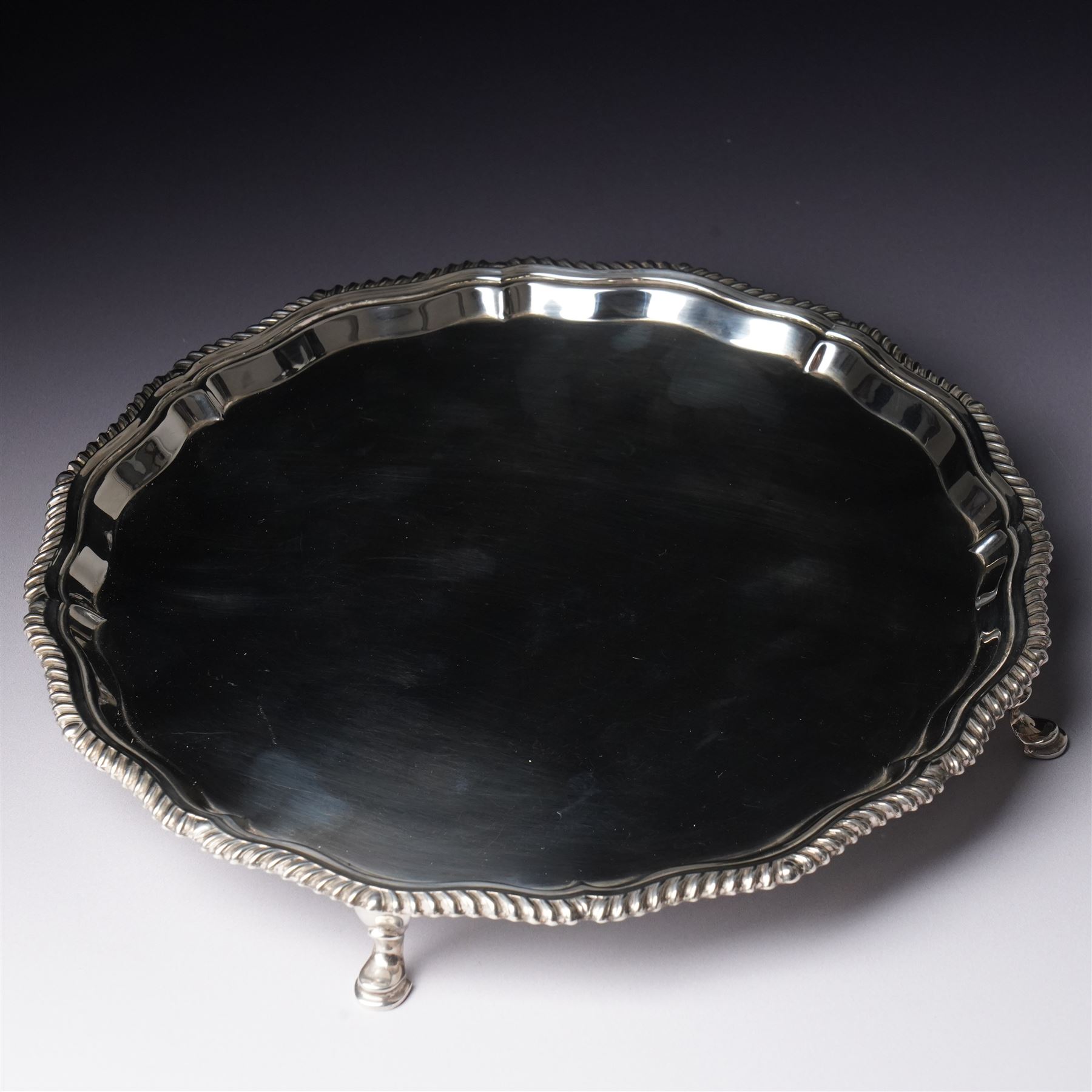 Silver circular salver with gadrooned border on shaped supports D25cm London 1968 Maker Edward Barnard & Sons Ltd