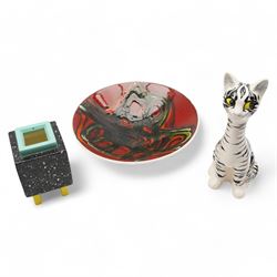 Poole pottery bowl, decorated internally with an abstract black and orange pattern, against a red ground, D27cm, together with a Christina Gray model of a Cheshire cat and an Art Deco vase (3)