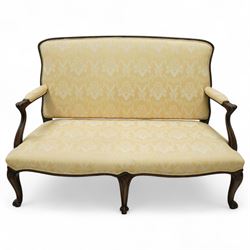 Early 20th century mahogany settee in the George III style, upholstered in pale yellow dam...
